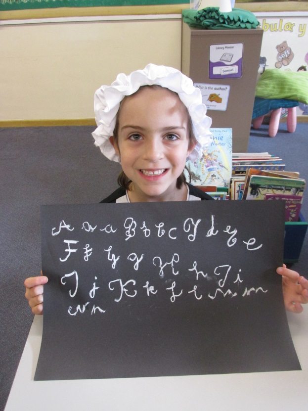 Downsend pupil writes calligraphy with chalk
